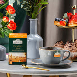Ahmad Tea Ceylon Tea 20 Teabags - Box with hot cup of tea on the afternoon table