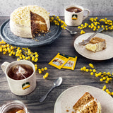 Ahmad Tea English Tea No. 1 Foil Teabags - Envelop teabags next to hot cups of tea and cake