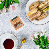 Ahmad Tea English Afternoon Foil Teabag - Envelop Teabag with hot cup of tea and sandwiches