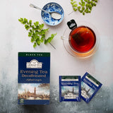 Ahmad Tea Evening Tea Decaffeinated 20 Teabags - box and envelop on the table next to cup of hot tea