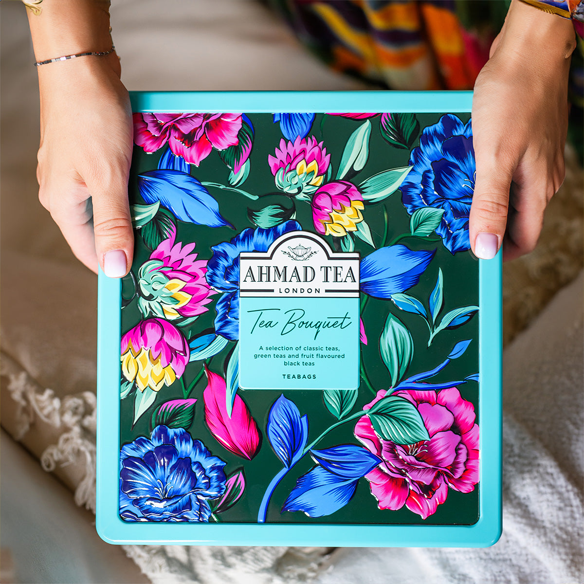 Floral caddy from  Ahmad Tea with hands holding it