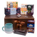 Ahmad Tea Christmas Sweet Indulgence gift set featuring Winter Wonder tea, fruity and herbal blends, cake, ceramic mug and teaspoons.