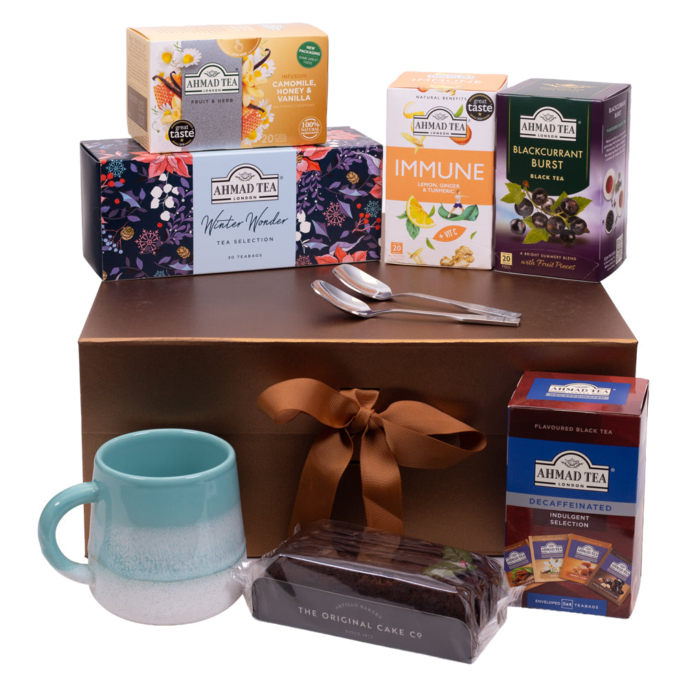 Ahmad Tea Christmas Sweet Indulgence gift set featuring Winter Wonder tea, fruity and herbal blends, cake, ceramic mug and teaspoons.