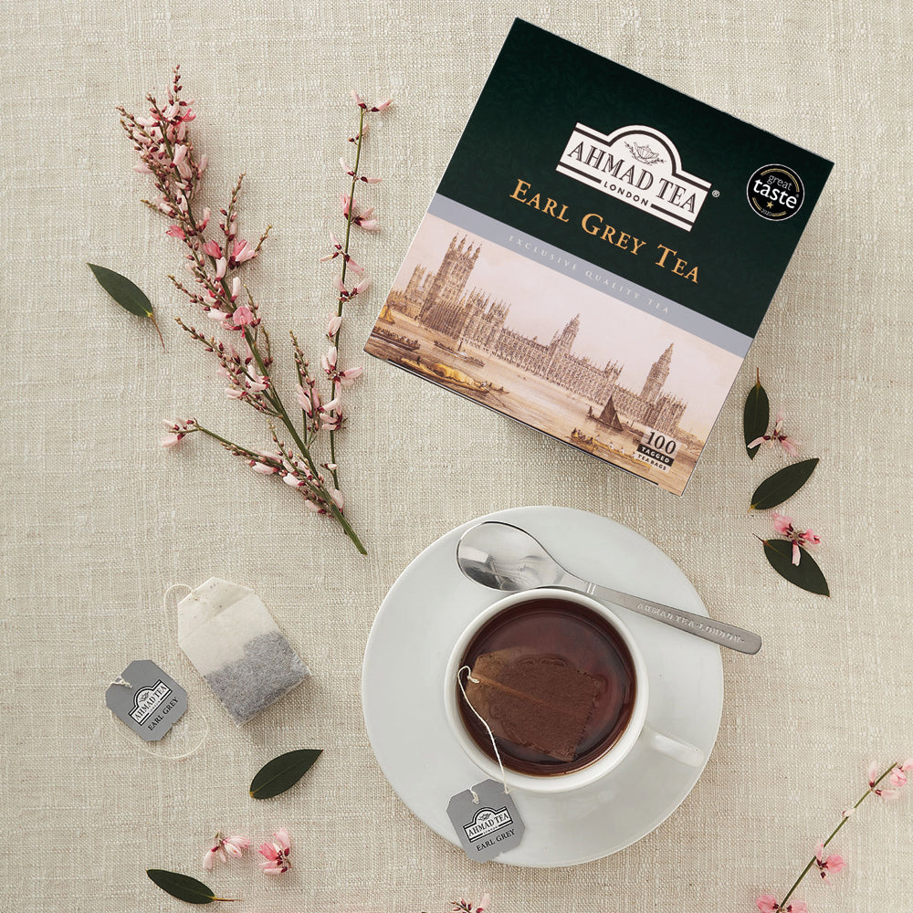 Ahmad Tea Earl Grey Tea 100 Teabags - Box with teabag next to hot cup of tea