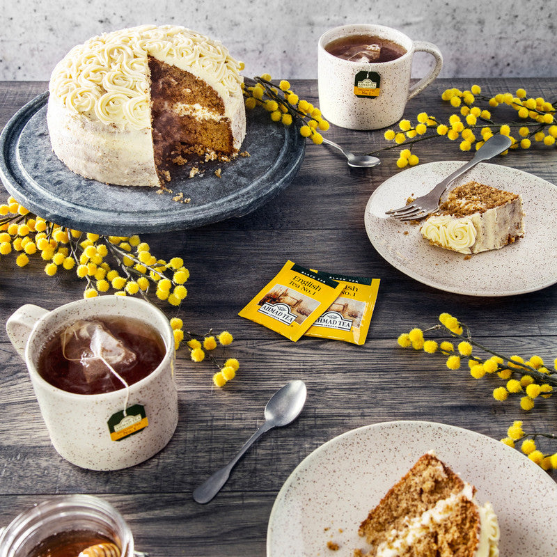 Ahmad Tea  English Tea No. 1 Foil Teabags - Envelop teabags next to hot cups of tea and cake