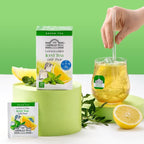 Ahmad Tea Lemon & Mint Iced Tea packaging with a glass of iced tea and lemons on a green background