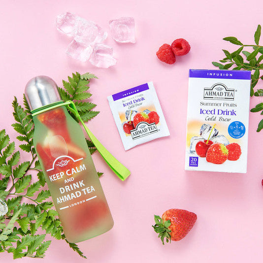  Ahmad Tea bottle and Summer Fruits Cold Brew Infusion with fruits and ice on a pink background